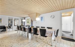 a dining room with a long table and chairs at Pet Friendly Home In Ringkøbing in Klegod