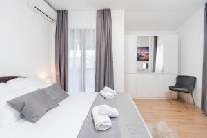 ein Schlafzimmer mit einem Bett, auf dem zwei Handtücher liegen in der Unterkunft Holiday Home DaLeo in Zadar + 62 Fotos