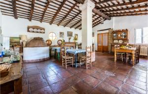 a kitchen with a table and chairs in a room at Lovely Home In Cazalla De La Sierra in Cazalla de la Sierra