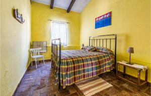 a bedroom with a bed and a table and a chair at Lovely Home In Cazalla De La Sierra in Cazalla de la Sierra