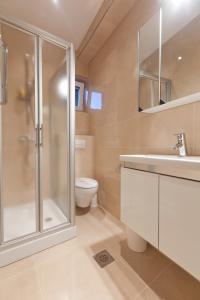 a bathroom with a shower and a sink and a toilet at Brela Beachfront in Brela +90 photos