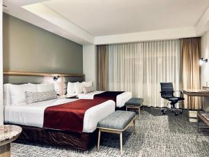 a hotel room with two beds and a desk at Crowne Plaza Hotel Mexico City North-Tlalnepantla, an IHG Hotel in Mexico City