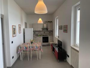 a kitchen with a dining room table and a refrigerator at Finestra sul mare in Marina San Vito