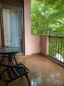 a balcony with a table and chairs and a window at Apartment Luka in Ljubuški