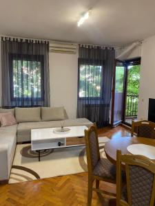 a living room with a couch and a table at Apartment Luka in Ljubuški
