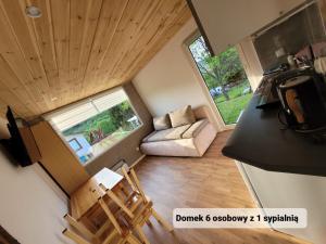 an overhead view of a tiny house with a living room at Ambasadorówka in Solina