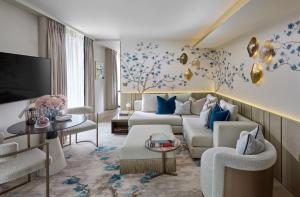 a living room with a couch and a tv at Mandarin Oriental Mayfair, London in London