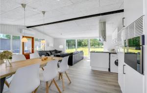 a kitchen and dining room with a table and chairs at 3 Bedroom Lovely Home In Spøttrup in Spottrup +19 photos