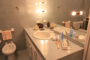 a bathroom with a sink and a toilet and a mirror at Casa Fracasso in Verona +81 photos