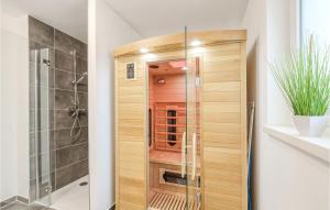 a shower with a glass door in a bathroom at Nice Home In Tossens With Kitchen in Tossenserdeich