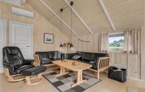 a living room with leather furniture and a table at Three-Bedroom Holiday Home In Nordborg in Nordborg