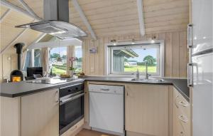 a kitchen with white cabinets and a sink and a window at Three-Bedroom Holiday Home In Nordborg in Nordborg +19 photos