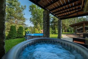 a hot tub in a backyard with a pool at Wellness Vila Limaco Slovakia in Horné Jaseno +25 photos