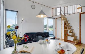 a living room with a table with a vase of flowers at Beautiful Home In Vestervig With Wifi in Vestervig