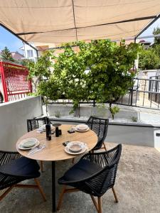 ein Holztisch und Stühle auf einer Terrasse in der Unterkunft Apartment Noa in Novi Vinodolski