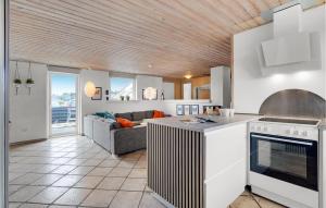 a kitchen and living room with a couch at Stunning Home In Ringkøbing With Sauna in Klegod