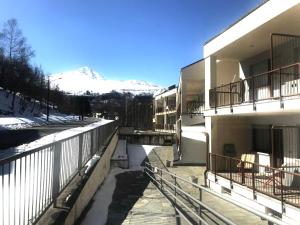 a building with a snow covered mountain in the background at Berto’s House in Montoso