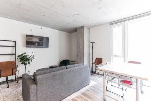a living room with a couch and a table at DT Delight Downtown Living One-bedroom Endless Access in Cleveland