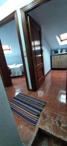 a room with a door and a rug on the floor at El portal de Beni in Pedro Bernardo +46 photos