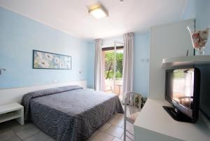Кровать или кровати в номере Hotel dei Coralli