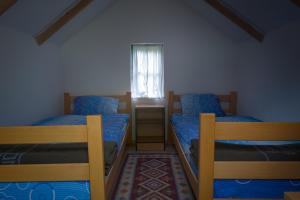 a bedroom with two bunk beds and a window at Rafting Camp Tara Center Tri Vodenice in Bastasi