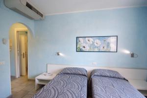 Кровать или кровати в номере Hotel dei Coralli