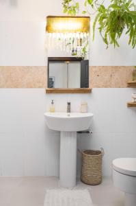 a bathroom with a sink and a toilet at Sixteen By Sixteen in Lagos +55 photos