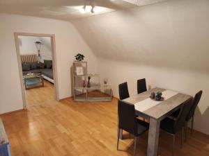 a dining room and living room with a table and chairs at Ferienwohnung Paul & Jakob in Nohfelden