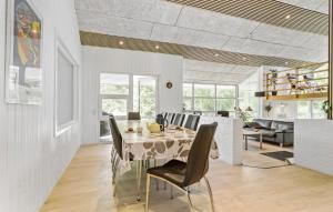 a dining room with a table and chairs at Cozy Home In Hirtshals With Kitchen in Hirtshals