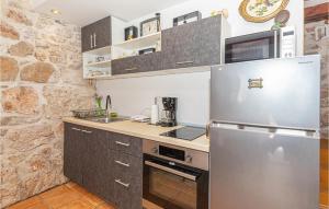 a kitchen with a stainless steel refrigerator and a sink at Awesome Home In Kaprije With Wifi in Kaprije