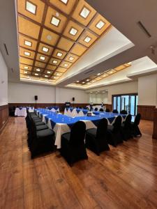 a large banquet hall with blue tables and black chairs at Balmoral Hotel San José CR, Historic District in San José