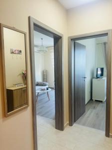 a hallway with a door and a mirror in a room at Kiwi Gardens in Byala
