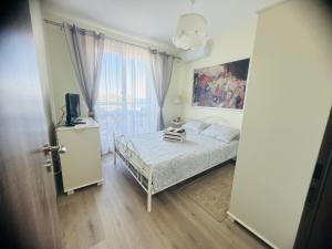 a bedroom with a bed and a television in it at Kiwi Gardens in Byala