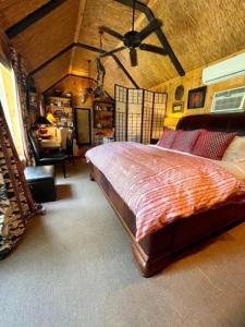 a bedroom with a large bed in a room at Sunflower Cottage on the River in Clarksdale