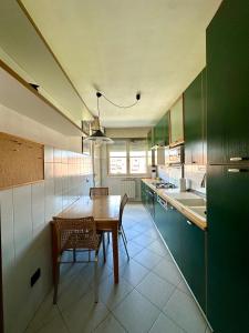a kitchen with a wooden table and chairs in it at Appartamento tranquillo e luminoso a Firenze in Florence