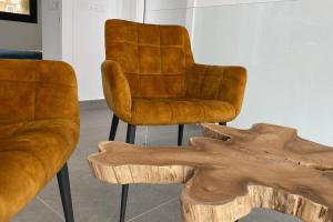 two leather chairs and a table with a wooden stump at Villa SolyMar in Polop Hills Luxury and comfort ! in Polop