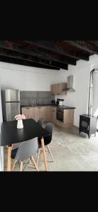 a dining room with a black table and chairs at Calavato Cottage in Kalavasos +6 photos