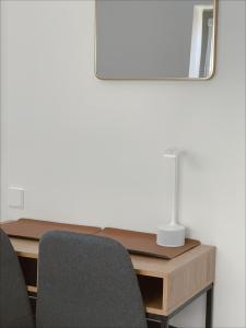 a desk with two chairs and a lamp on it at Nidos Baltija in Nida