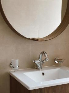 a bathroom sink with a large mirror above it at Nidos Baltija in Nida +2 photos