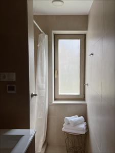 a bathroom with a shower and a window at Nidos Baltija in Nida