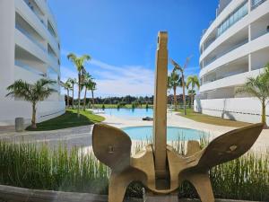 a statue of a pair of scissors in front of a building at PUSHE Playa Granada Beach & Golf 31 in Motril
