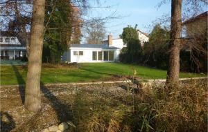 a white house with trees in the yard at Lovely Home In Heidesee Ot Wolzig in Heidesee