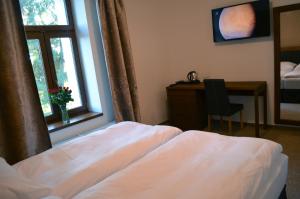 Letto o letti in una camera di Hotel U Kvapilů