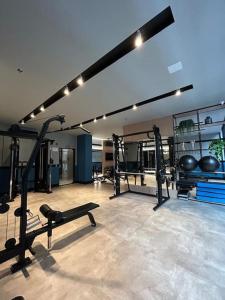 a gym with two treadmills and weights in a room at Flat 1609 Infinity Tower in Itapema