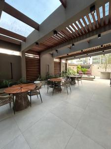 a patio with tables and chairs in a building at Flat 1609 Infinity Tower in Itapema
