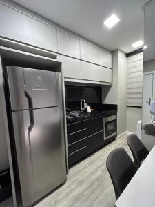 a kitchen with a stainless steel refrigerator and a counter at Flat 1609 Infinity Tower in Itapema