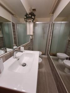 a bathroom with a white sink and two toilets at OASI San Lorenzo in Genova +38 photos