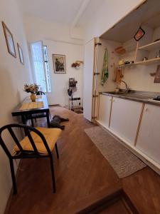 a living room with a table and a kitchen at OASI San Lorenzo in Genova