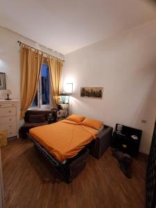 a bedroom with a bed with an orange blanket at OASI San Lorenzo in Genova