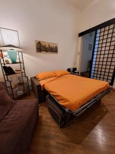 a bedroom with a bed and a couch at OASI San Lorenzo in Genova